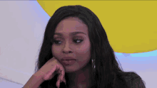 a woman with her hand on her chin looks sad