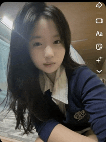 a girl wearing a blue sweater with a badge that says ' sd ' on it