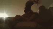 a blurry photo of a man laying on a bed