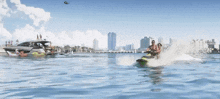 a man and woman are riding a green and purple jet ski in the water