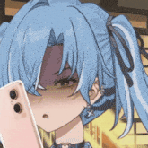 a girl with blue hair is taking a picture of herself with her phone .