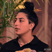 a close up of a woman 's face with the word netflix on the bottom right