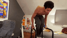 a man without a shirt is doing push ups on a bar