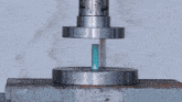 a machine is working on a piece of metal and there is smoke coming out of the cylinder