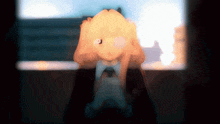 a blurred image of a person holding their head with a light shining on it