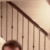 a close up of a person standing on a set of stairs .