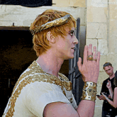 a man in a white and gold costume has the name joequinngraves on the bottom