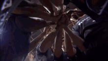 a group of people putting their hands together with one wearing a shirt that says ' stechco ' on it