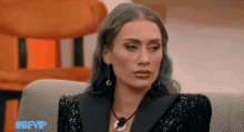 a woman sitting on a couch with the hashtag #gfvip on the bottom right