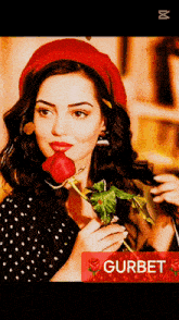 a woman wearing a red beret is holding a red rose with the word gurbet below her