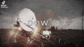 a black and white photo of a plane flying through the air with the words dow 6 written on it .