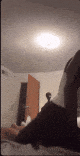 a person is laying on a bed in a room with a door open