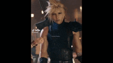 a man in a cloud strife cosplay is holding a star in his hand .