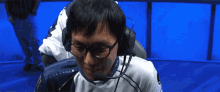 a man wearing glasses and a headset with the word alienware on the back of his shirt