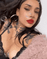 a woman with a tattoo on her chest that says e on it