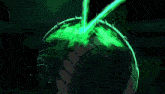 a dark room with a green glowing object on the floor