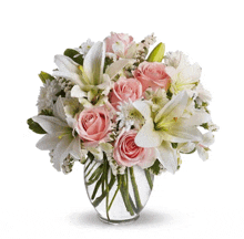 a clear vase filled with pink and white flowers