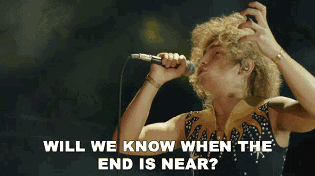 a man singing into a microphone with the words 