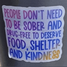 a sign that says people don t need to be sober and drug-free to deserve food shelter and kindness