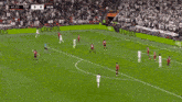 a soccer player wearing an aia jersey is running in front of a crowd