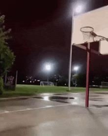 a basketball court is lit up at night with a sign that says ' a ' on it