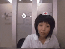 a woman wearing a nurse 's hat with a red cross on it