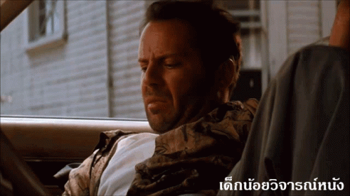 a man is sitting in a car with a foreign language overlay
