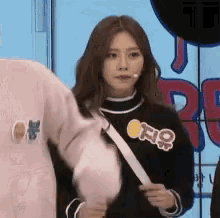 a woman wearing a black sweater with the word o on it