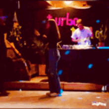 a woman standing in front of a turbo sign
