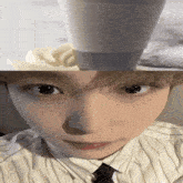 a close up of a person 's face with a cup of milk on top