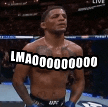 a man without a shirt is standing in a boxing ring with his hands on his hips and says lma .