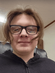 a man wearing glasses and a black jacket has a sticker on his face that says m.z.