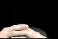 a close up of a person 's hands with a ring on one finger