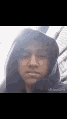 a close up of a person wearing a hoodie .
