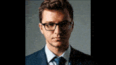 a man wearing glasses and a suit and tie