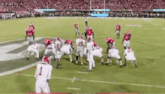 a football game is being played on a field with a lot of people watching .