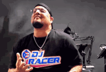 a man wearing a dj racer t-shirt is making a funny face