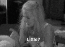 a black and white photo of a woman laying on a bed with the words little written on the bottom