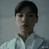 a close up of a woman 's face with the word netflix on the bottom right