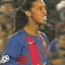 a blurry picture of a soccer player wearing a blue shirt