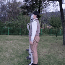 a man wearing a face mask is laying on a bench in a park