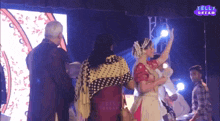 a group of people are dancing in front of a telly dream sign