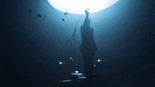 a silhouette of a person holding up a microphone in the dark