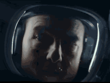 a close up of a man 's face in a helmet