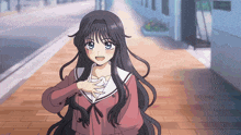 a girl with long black hair and blue eyes stands on a sidewalk