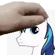a person is petting a pony 's head with a towel on it .