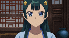 a girl with a flower in her hair is covering her mouth