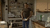 a man in a kitchen with a plate of food