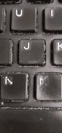 a close up of a keyboard showing the keys u j k and m