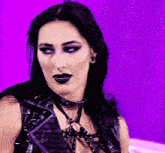 a woman wearing a choker with the word cruel on it looks at the camera